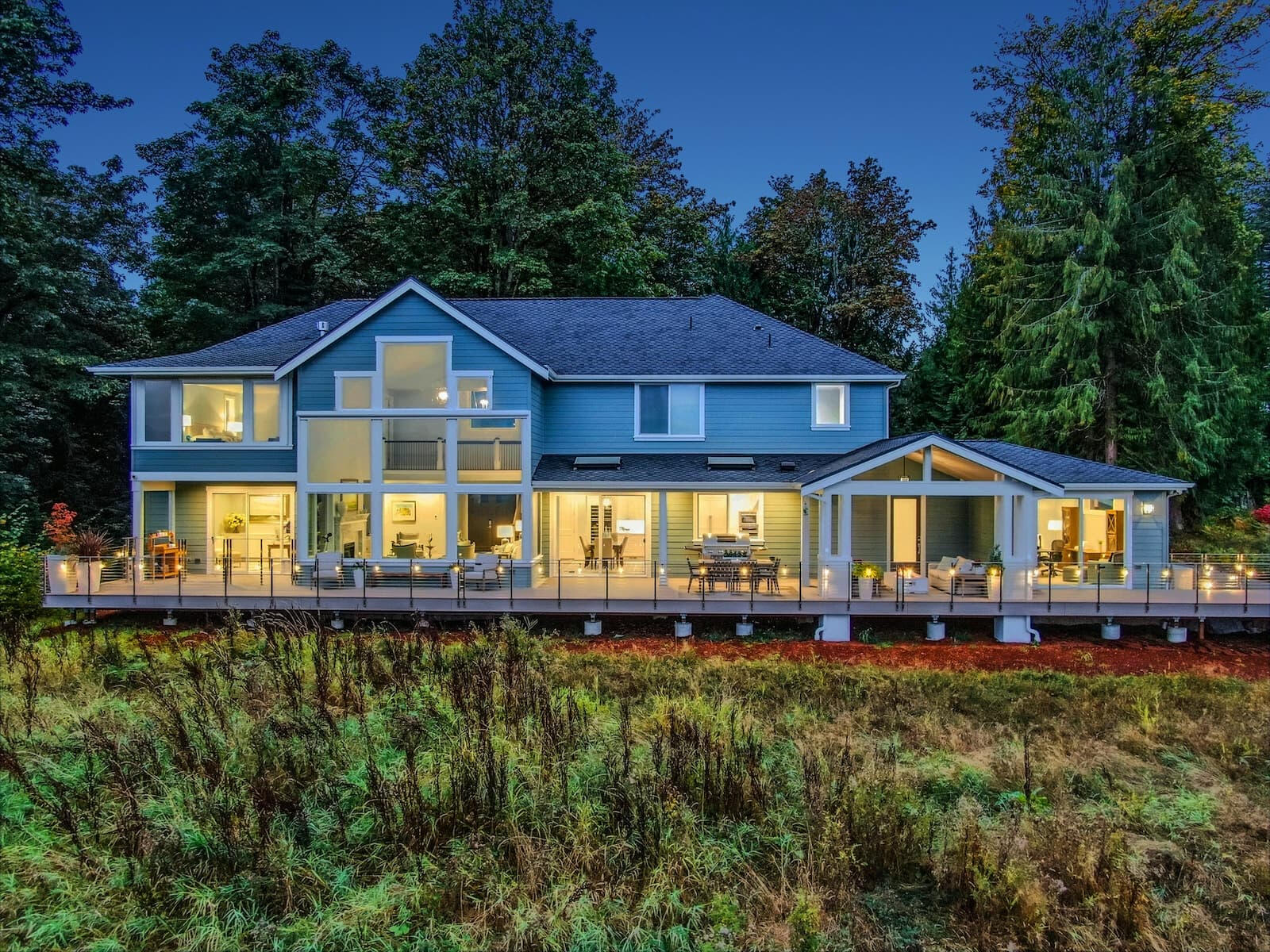 Smart Exterior Lighting & Shades Modern home featuring beautiful exterior lighting, deck lighting, and automated shades designed with smart home technology by Alpha Concepts